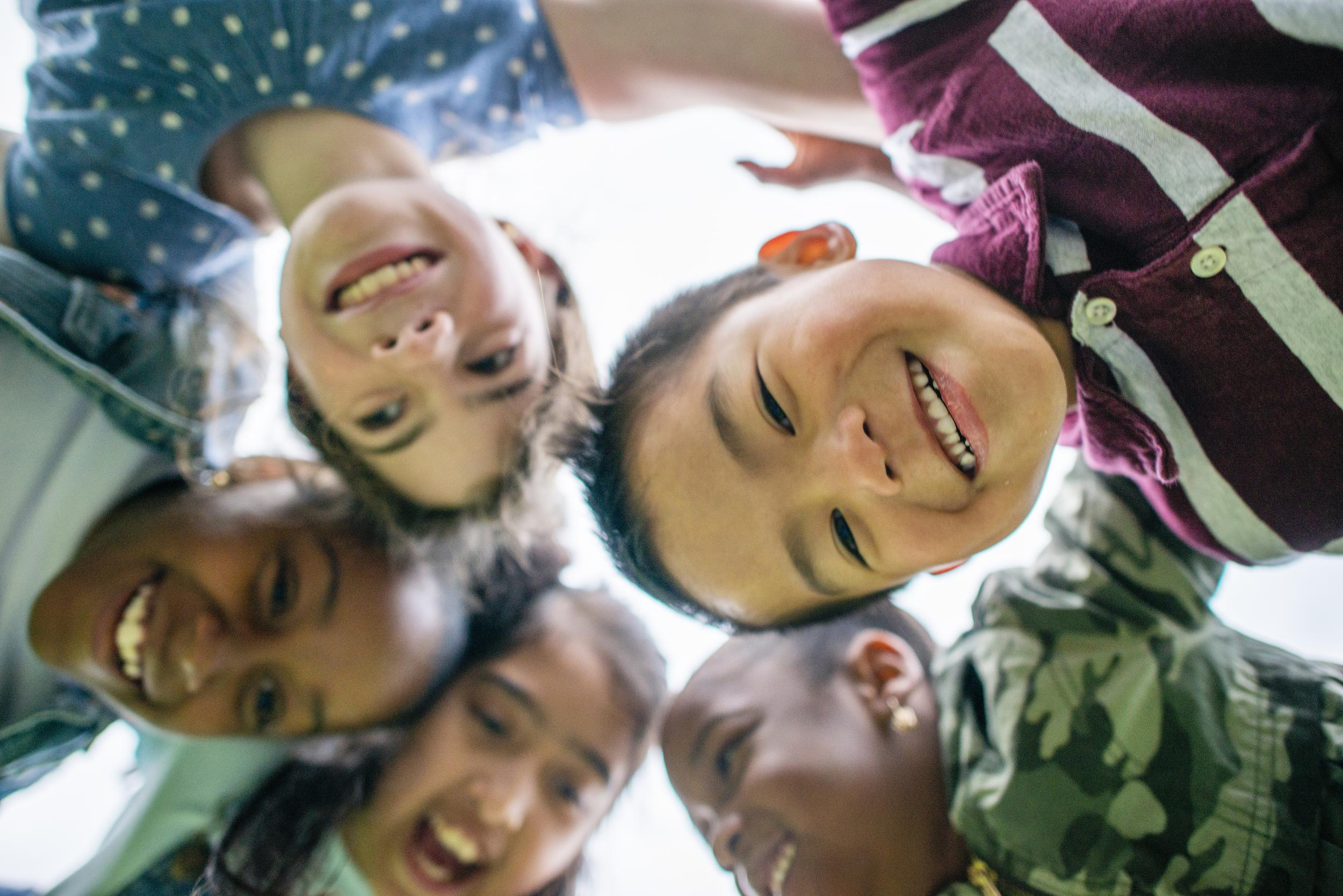 group of young children looking down from circle